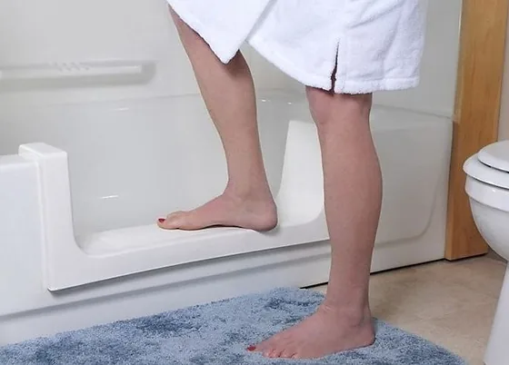 Person safely stepping into a tub cut conversion